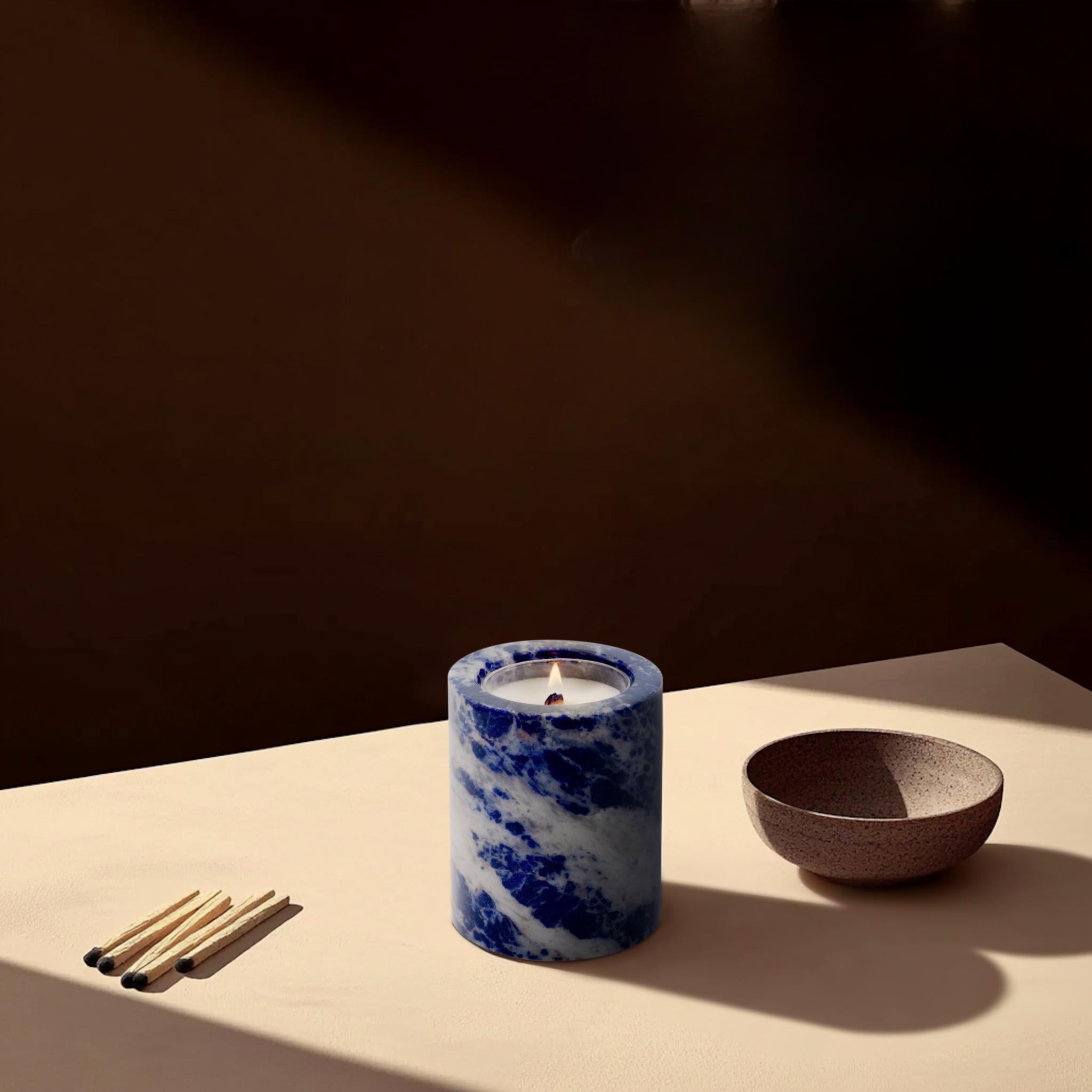 Lit sodalite candle holder in a minimalist setting – modern crystal home decor accent